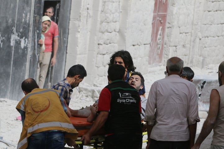 A man reacts while being carried on a stretcher after airstrikes on the rebel held al-Qaterji neighbourhood of Aleppo, Syria