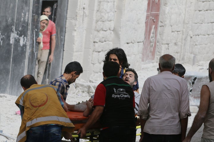 A man reacts while being carried on a stretcher after airstrikes on the rebel held al-Qaterji neighbourhood of Aleppo, Syria September 21, 2016.