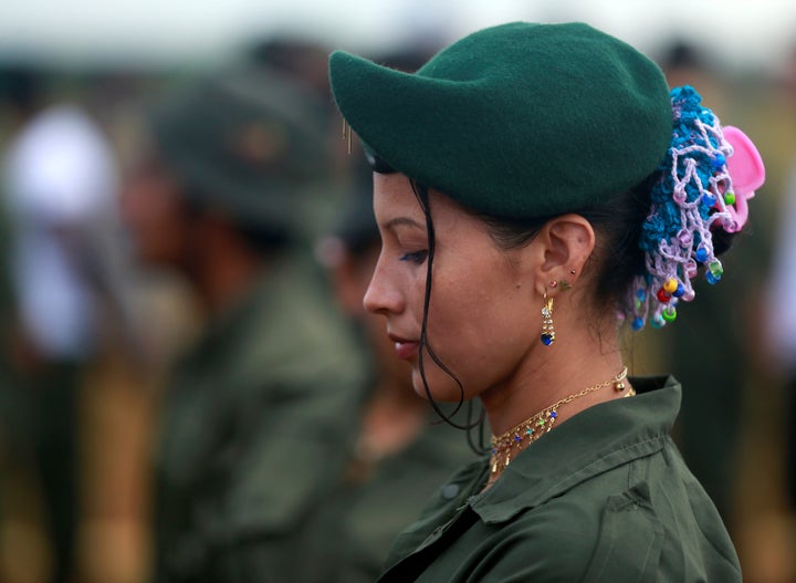 A FARC fighter stands in line during the opening of ceremony congress at the camp where they prepare for ratifying a peace deal with the government.