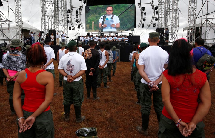 FARC rebel leader Rodrigo Londono is seen on a screen during the opening of ceremony congress at the camp.