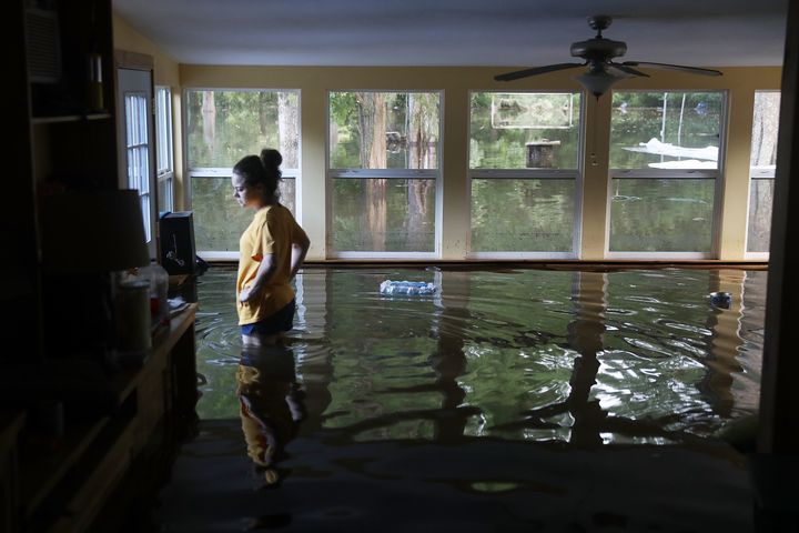 Leslie Andermann Gallagher stands in her flooded home on Aug. 17, 2016 in Sorrento, Louisiana.