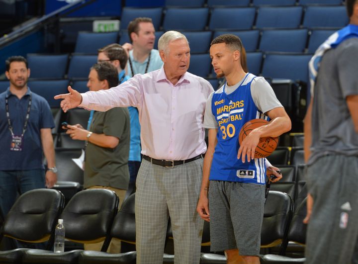 NBA Hall of Famer Jerry West speaking with the league's reigning two-time MVP Stephen Curry during the NBA Finals.