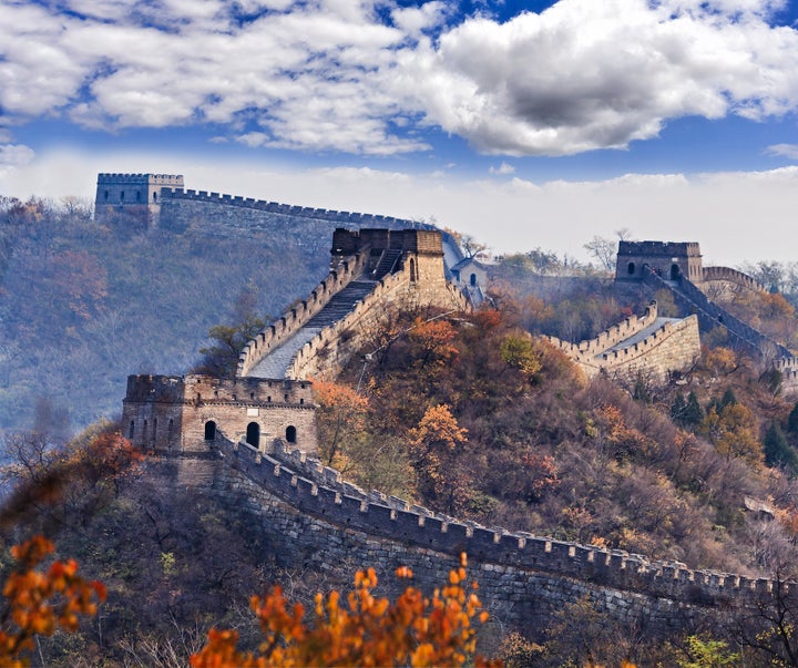 Several towers of the Great Wall of China near Mutianyu, north of Beijing, high in mountains at autumn.