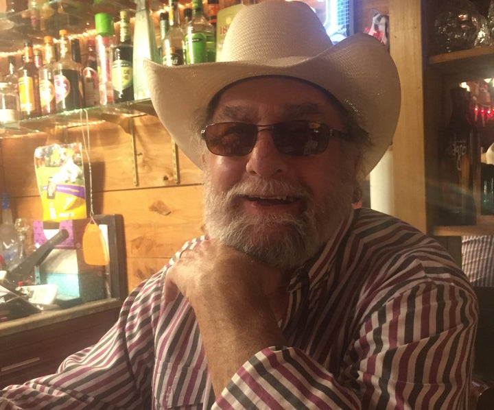 Howard “Wayne” Neal at "Wayne's Hurricane Bar," a bar in his office that was built out of solid concrete to