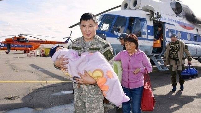 Tserin Dopchut is carried to safety by a member of the Tuva Emergency Services 