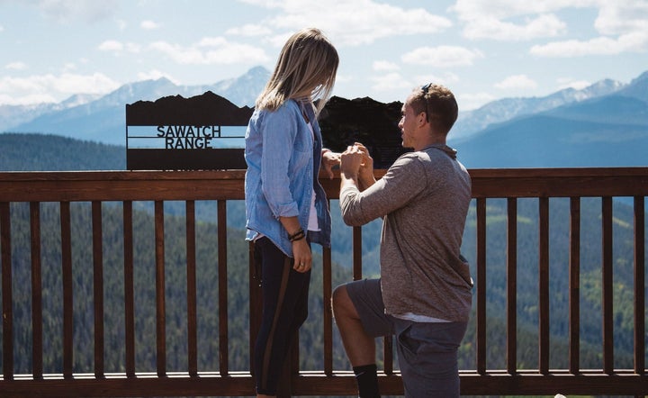 A proposal with a breathtaking view of the Rocky Mountains.