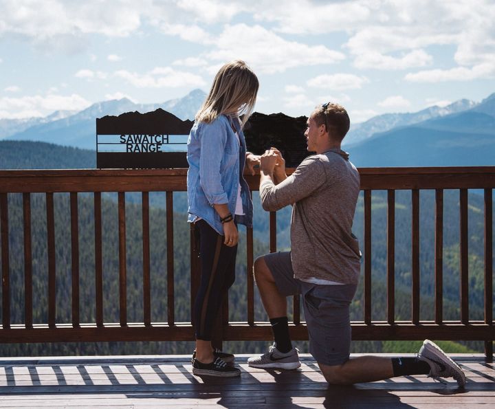 A proposal with a breathtaking view of the Rocky Mountains.