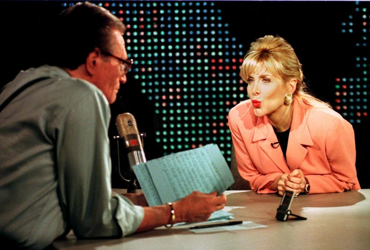 Gennifer Flowers blows a kiss to Larry King during an interview. Former President Bill Clinton admitted to having an affair with Flowers while he was governor of Arkansas.