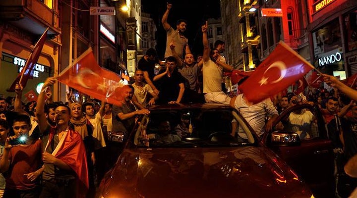 People chant slogans during a pro-government rally in Istanbul's Taksim Square.