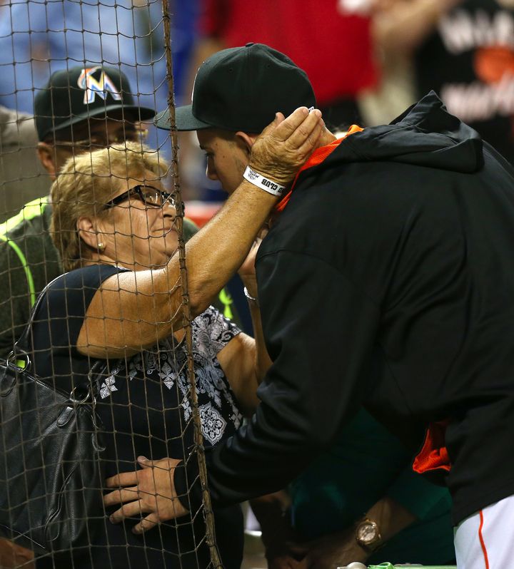 The Cuban-born pitcher is seen embracing his grandmother, Olga, following a 2-0 win against the Cincinnati Reds in July 2015.