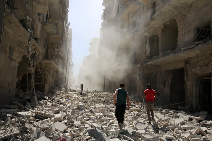 Men inspect the damage after an airstrike on the rebel held al-Qaterji neighbourhood of Aleppo, Syria September 25, 2016.