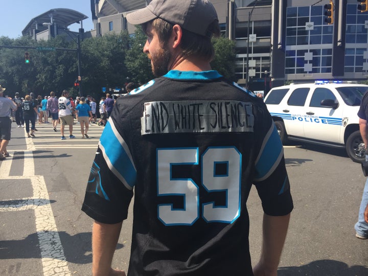 Todd Zimmer, who helped organize Sunday's rally, wears a Carolina Panthers jersey outside the game.