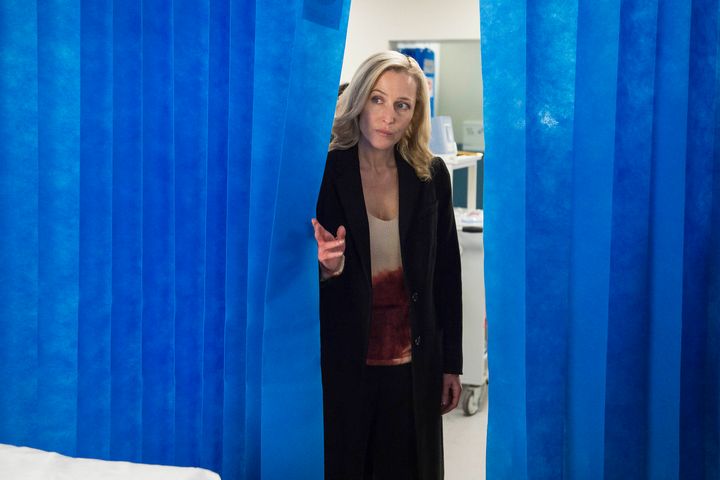 Stella Gibson (Gillian Anderson) waits as medics try to save her suspect, Paul Spector