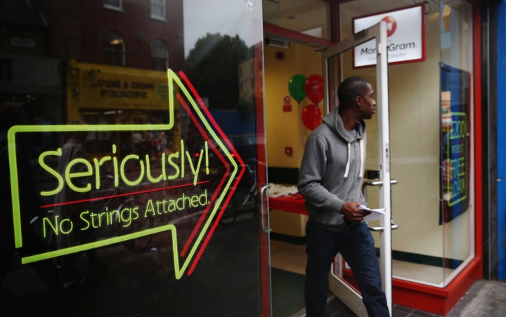 A man walks out of a payday loan store in London on Oct. 3, 2013.