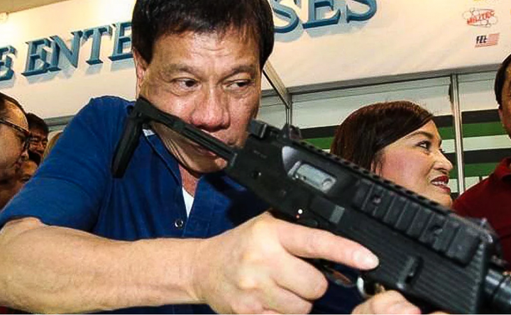 President Duterte displays his gun wielding skills.