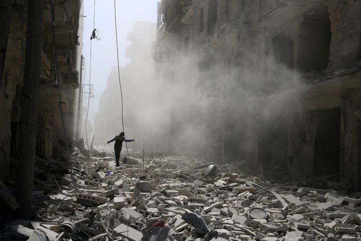 A man walks on the rubble of damaged buildings after an airstrike on the rebel held al-Qaterji neighbourhood of Aleppo, Syria September 25, 2016