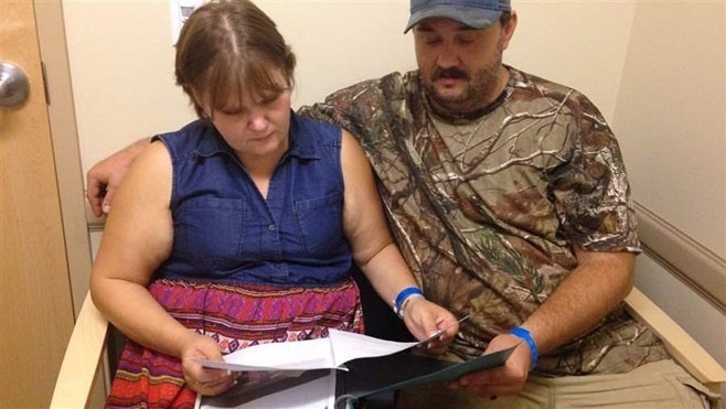 Jillian and Glen Coleman look over counseling and group therapy schedules at Valley Health in Huntington, West Virginia. Like much of the rest of the country, the city’s opioid treatment centers are struggling to meet burgeoning demand.