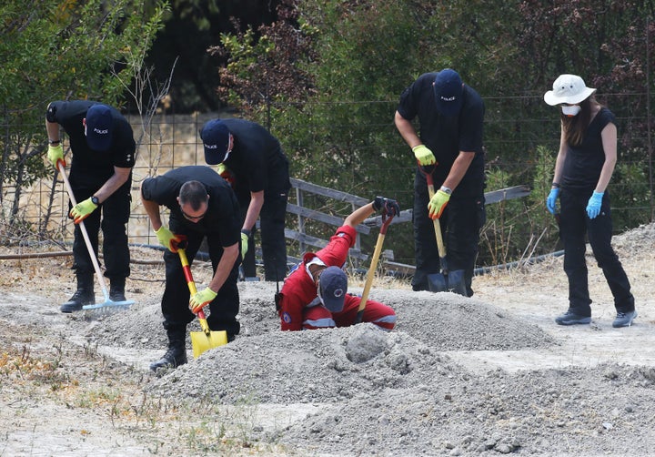 South Yorkshire Police search officers sift through piles of earth taken from an olive grove near the scene where toddler Ben Needham went missing.