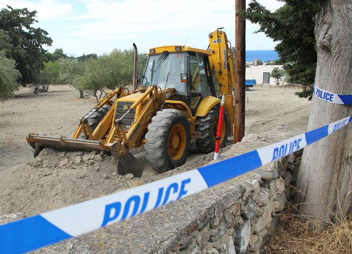 Police use a digger to investigate the olive grove.