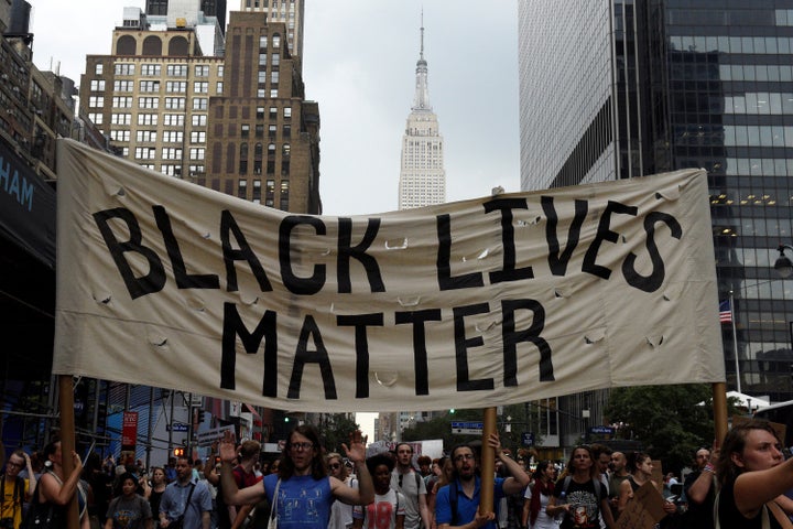 People take part in a protest against the killings of black men by police.