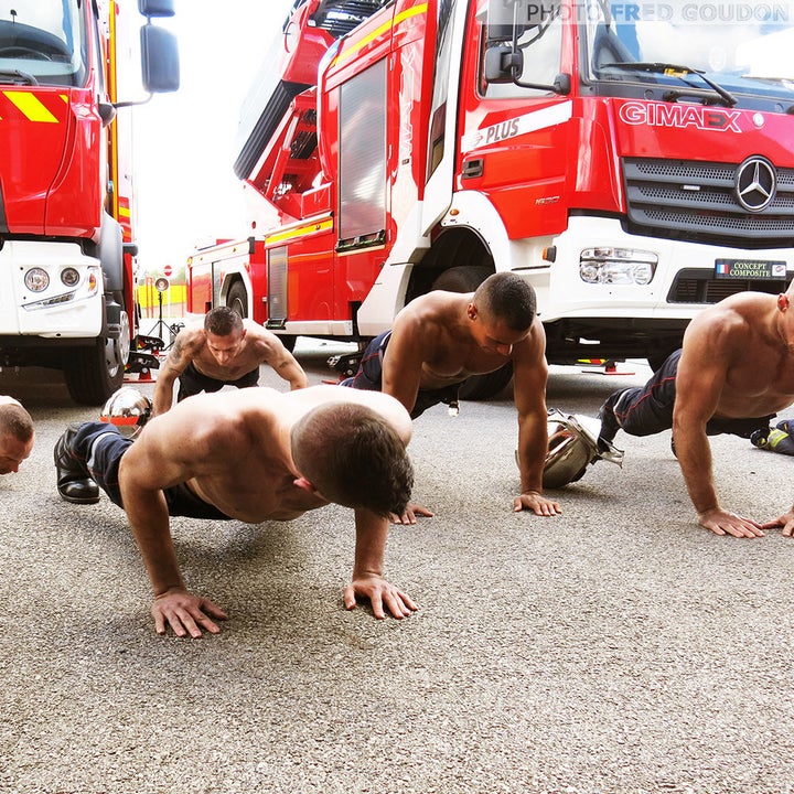 Firefighters doing push-ups for the calendar.