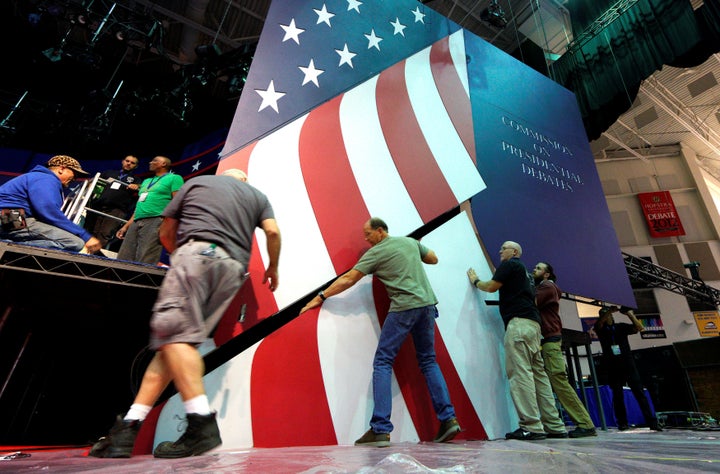 Workers install part of the stage for the first U.S. presidential debate at Hofstra University in Hempstead, New York, on Sept. 24, 2016. 