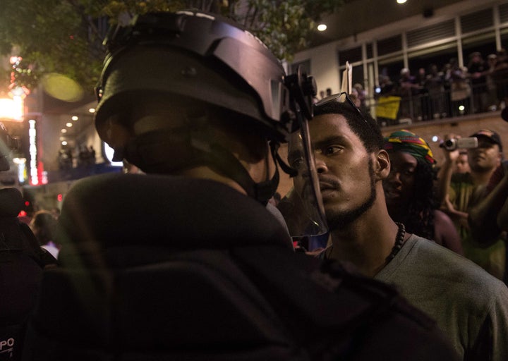 A protester stares at riot police during a demonstration against police brutality in Charlotte. 