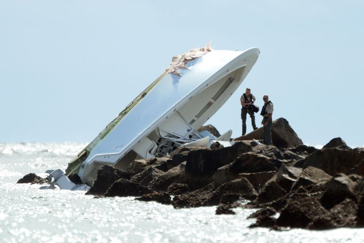 Investigators look over the overturned boat in which Miami Marlins pitcher Jose Fernandez was killed, Sunday, Sept. 25, 2016, in Miami Beach.