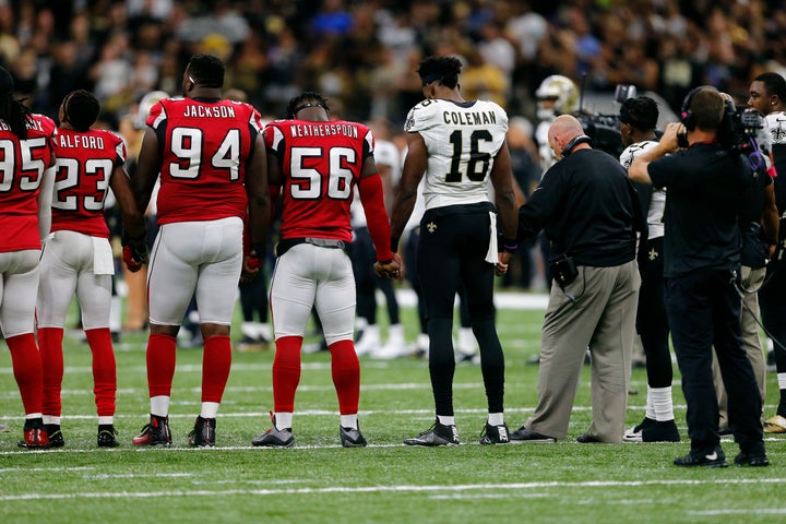 New Orleans Saints and Atlanta Falcons players form a unity circle before an NFL football game in New Orleans on Sept. 26.