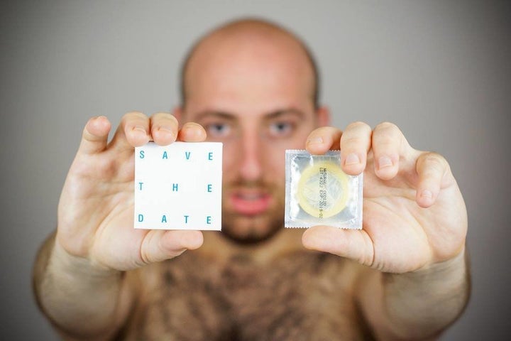 Badasyan with two promotional condoms for "SAVE THE DATE."