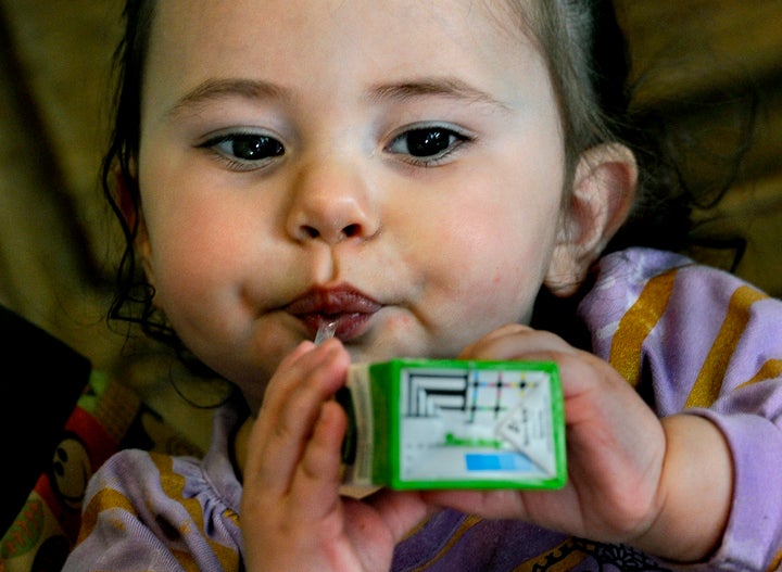 WOONSOCKET, RI - MARCH 01: One-year-old Jaeliece Ortiz enjoys some of the food (fruit juice) her mother (Rebecka Ortiz) just brought home after shopping with her SNAP (food stamps) card.