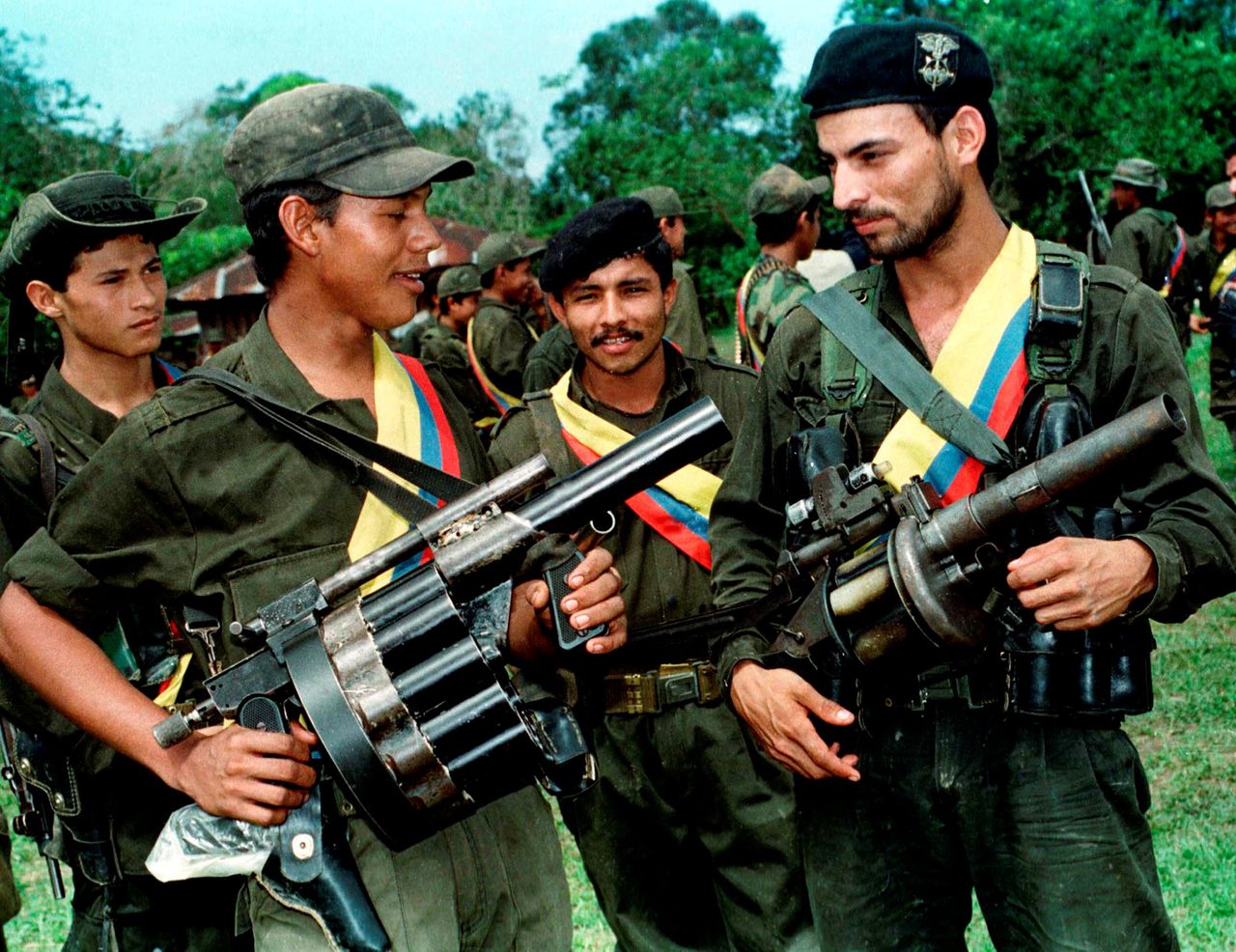 FARC fighters pose with their weapons after a patrol in the jungle near the town of Miraflores. Aug. 7, 1998.