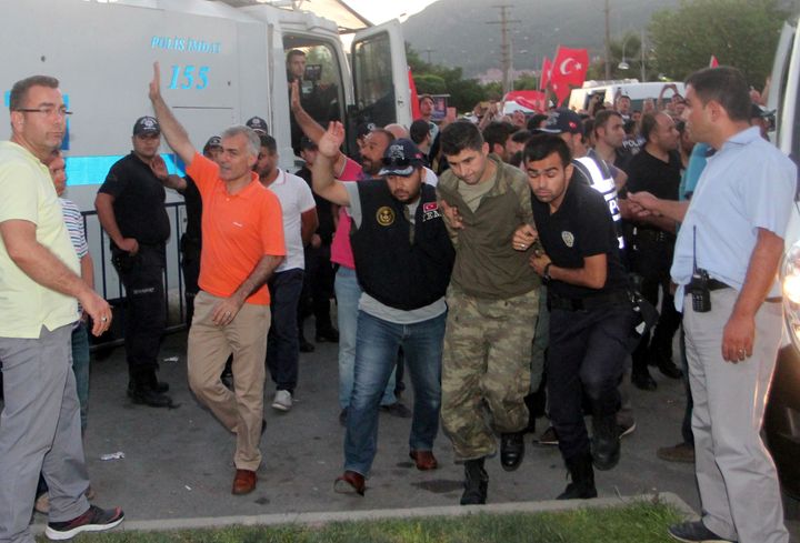 Soldiers suspected of being involved in the coup attempt are escorted by policemen to a courthouse in Marmaris, Turkey,