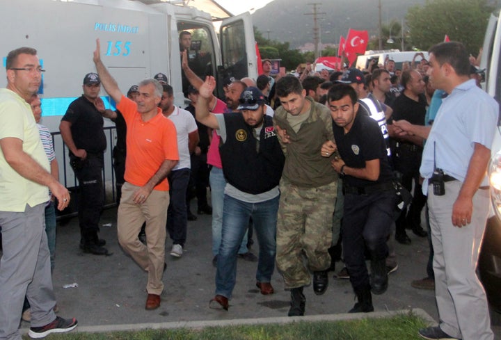 Soldiers suspected of being involved in the coup attempt are escorted by policemen to a courthouse in Marmaris, Turkey,