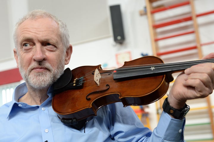 Corbyn plays the violin on a visit to a school in Liverpool