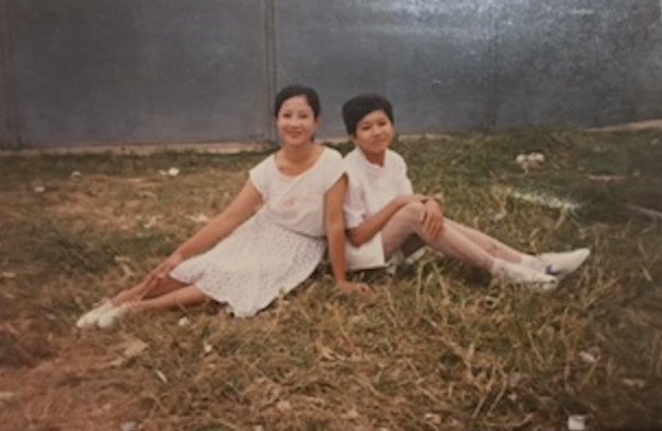 Kathy and her mother at their second refugee camp in six months, 1990.