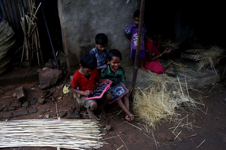 Slum living children are seen as they are practicing alphabet letter at a slum on the eve of World Literacy Day in the eastern Indian city Bhubaneswar, Wednesday, 07 September 2016.