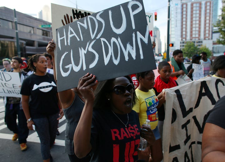 Demonstrators march to protest the police shooting of Keith Scott in Charlotte, North Carolina.