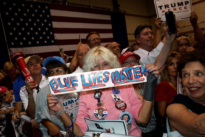 A woman holds a sign reading "Blue Lives Matter" as Republican presidential nominee Donald Trump holds a rally with supporters in Aston, Pennsylvania, U.S. September 22, 2016.