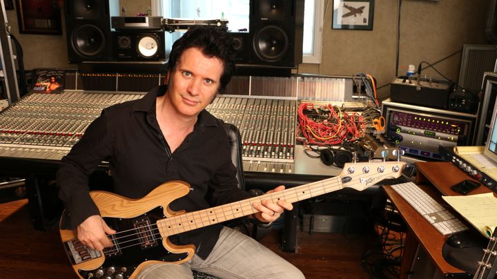 Warren in his studio on bass guitar, one of seemingly dozens of instruments on which he is a master!
