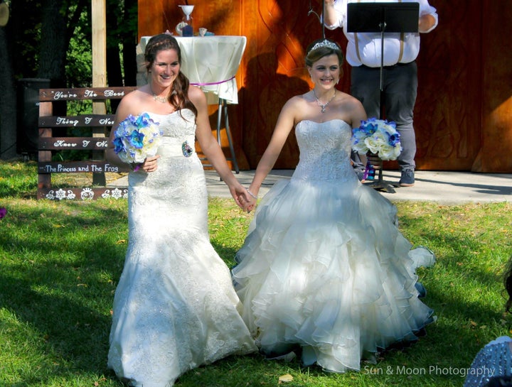 The beaming brides on their wedding day.