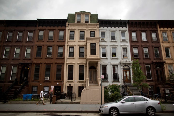 Brownstone buildings loom over a street in Bedford-Stuyvesant, Brooklyn's largest residential neighborhood.