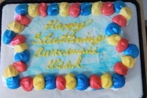 Why not bring celebrate stuttering with cupcakes? Description: photo of a decorated cake that reads "Happy Stuttering Awaren