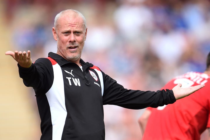 Barnsley coach Tommy Wright has been suspended following allegations he took a £5,000 payment to help place players at his club.