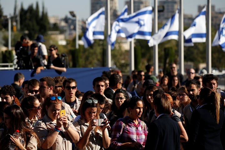 Israelis look on as the flag-draped coffin of former Israeli President Shimon Peres, is displayed at the Knesset plaza, the I
