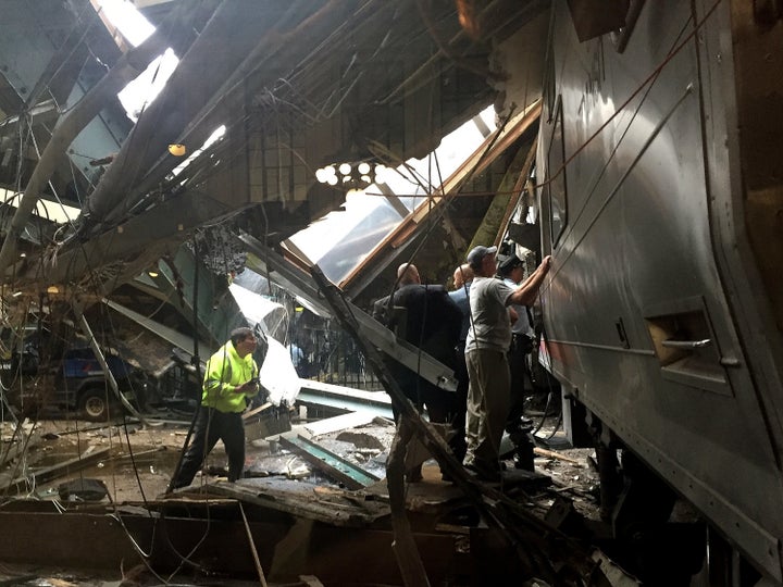 Train personnel survey the NJ Transit train that crashed into the platform at Hoboken Terminal on Sept. 29, 2016.