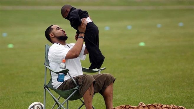 Joseph Arradondo plays with his son during his daughter’s soccer game in Brooklyn Park, Minnesota. Arradondo attended a Minnesota “co-parent” court that helps separated couples divvy up parenting responsibilities.