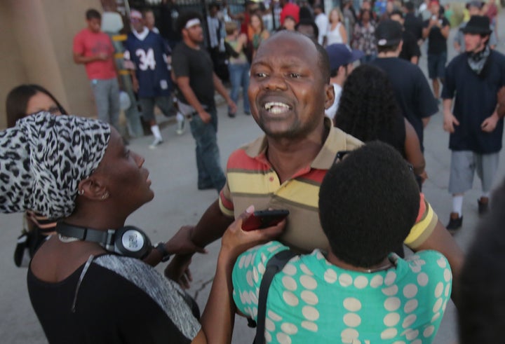 A man claiming to be Alfred Olango's cousin shouts at police during a rally in El Cajon.