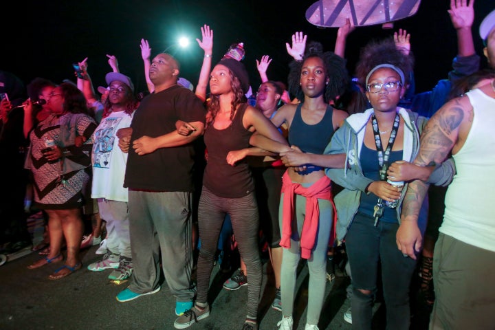 Protesters lock arms in front of a police line in El Cajon, a suburb of San Diego, California.