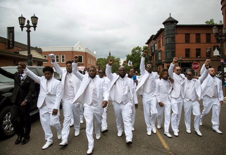 Pallbearers lead a march down Selby Avenue after the funeral of Philando Castile.